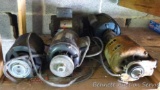 Five electrical motors, some include pulleys and cords.