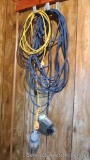 Two extension cords and a trouble light. One cord has rewired ends.
