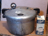 Co-Op brand pressure cooker has original wooden handles; plus a partial box of Ball zinc caps.