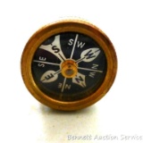 Marble's brass lapel compass is in good condition and points north.