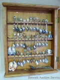 Spoon display cabinet with assortment of spoons. Cabinet measures 20