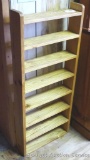 Wooden display shelf has been used as a mug rack. Could be hung on the wall, currently is standing