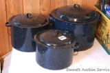 Set of three speckled enameled pots with lids. Largest has a jar rack, some damage noted to bottom