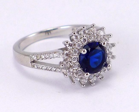 Seller's note states "3 CT sterling silver blue sapphire and topaz ring, size 7".