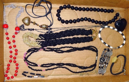 Beaded necklaces and bracelets; most are black and gold/white; longest necklace is 26".