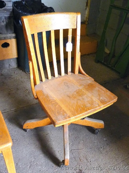 Wooden swivel office chair on rollers 17" x 18" x 34" tall.