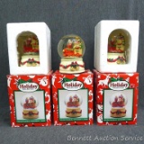 Three Holiday Collection snow globes come with boxes. One has lost some water, and they look a