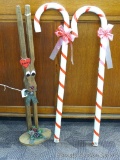 Wooden Rudohlf reindeer and two candy canes, all a little over 3'. Reindeer's nose lights up when