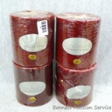 Four large cranberry scented candles. Candles each have three wicks and measure about 5-1/2