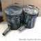 Two 5 gallon gravity pail feeders or similar are painted camouflage.