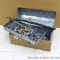 Metal galvanized homemade tool box with removable tray filled with plumbing supplies, drills,