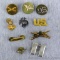 U.S. Army branch insignia pins including Field Artillery, Armor, Aviation, Quartermaster Corps. Plus