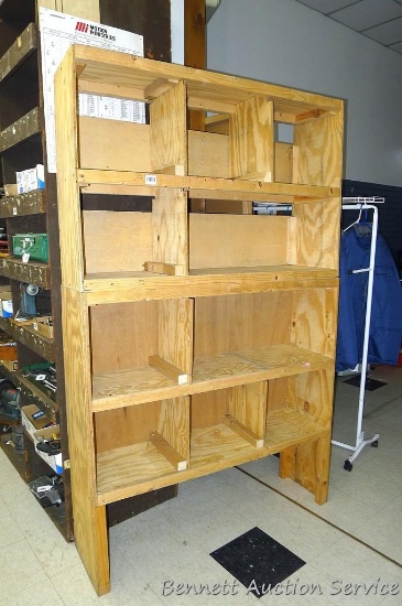 Wooden storage bin is 49" x 79" x 12" deep, made out of plywood, compartments sizes vary.