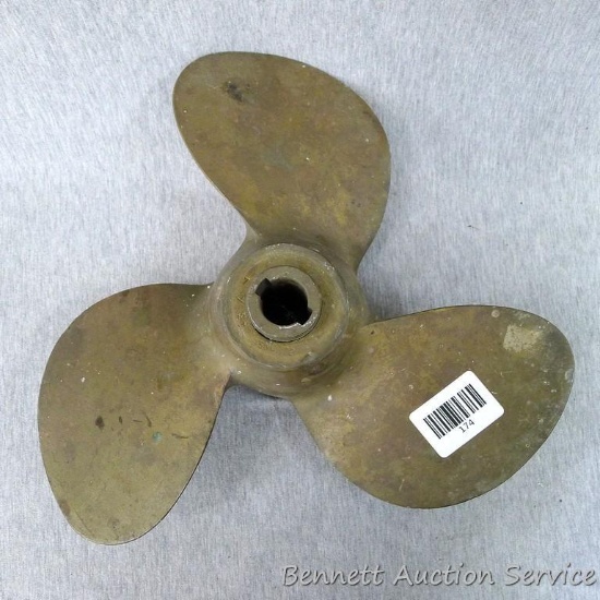 Three blade brass boat motor prop is about 12" across. Looks to be in good shape.