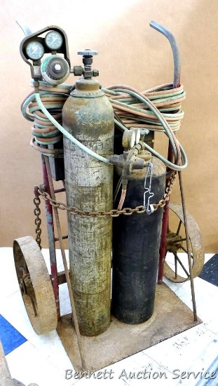Older oxygen and acetylene torch set comes with a heavy duty metal framed cart and torch