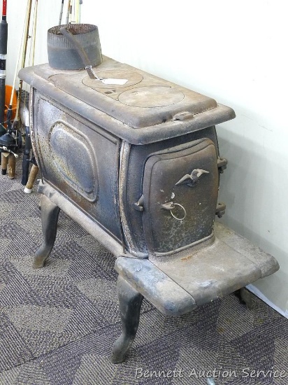 Cast iron wood stove is about 13" x 34" x 24" tall. Stove has a 6" pipe and is a nice little stove.