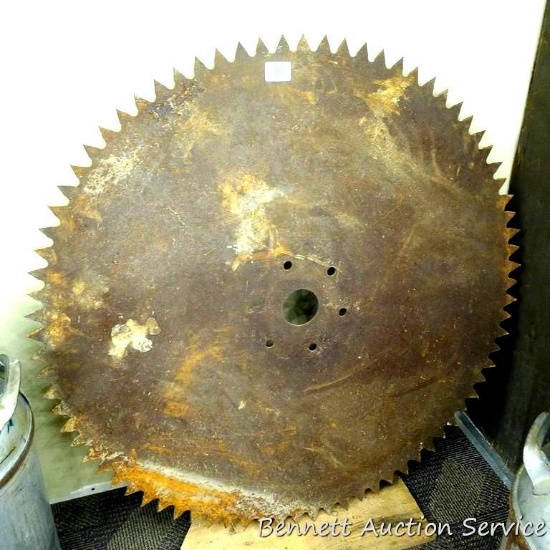 Large circular saw blade is about 39" across. Has a 2-3/4" center hole and some teeth are shorter
