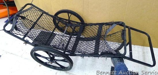Metal framed deer carrier with 18-1/2" wheels. Unit is 44" tall x 16" wide.