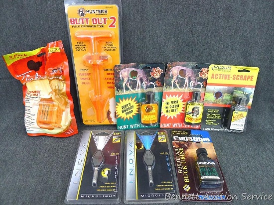 Assortment of whitetail lures includes Active Scrape, Acorn, buck urine; Heated buck lure dispenser;