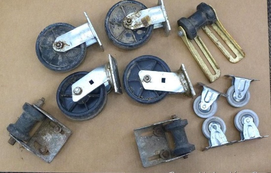 Bucket of casters and boat trailer guide rollers. Largest casters are 6", two swiveling and two