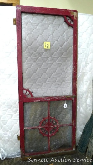 Charming wood framed screen door is approx 32" x 79". Bottom piece of door is loose, but has hinges.