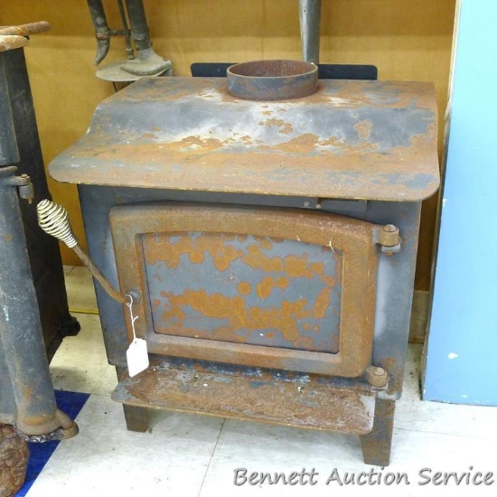 Warnock Hersey brick lined wood stove is 23" x 19" x 25" tall and has surface rust. Stove is heavy,