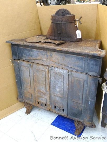 Cast iron fireplace woodstove can be used for decoration, is rusted on inside and back legs are