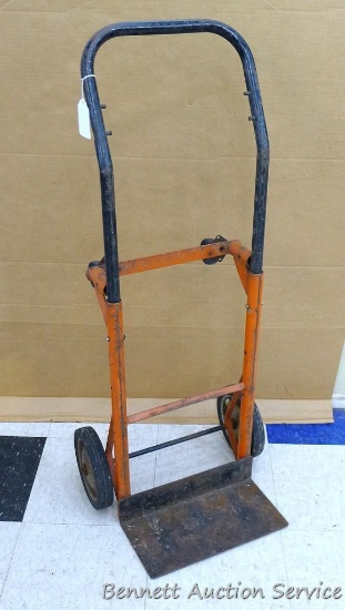 4 Wheel metal hand cart with movable handle is 14" x 12" x 43" tall with hand as a hand truck.