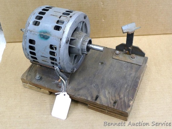 General Electric motor mounted on a wooden board, turns but is untested, 7-1/2" x 6" x 1/2" shaft.
