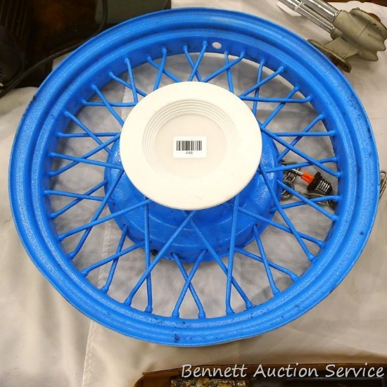 Tire rim painted up and made into a hanging light fixture; measures 5-1/2" x 20" diameter.