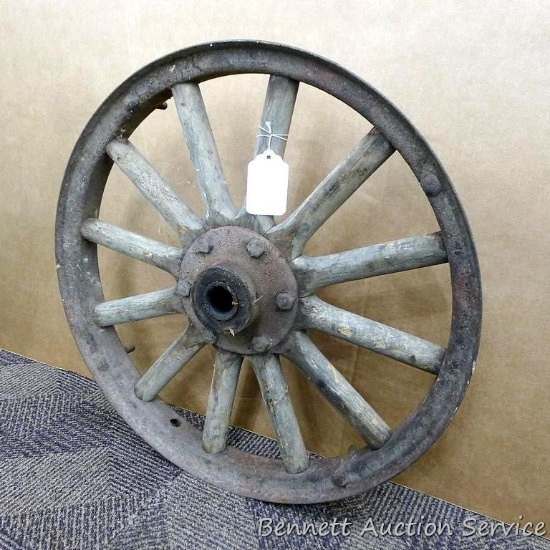 Antique wheel has wooden spokes and is about 21" across. Would make a very neat chandelier.