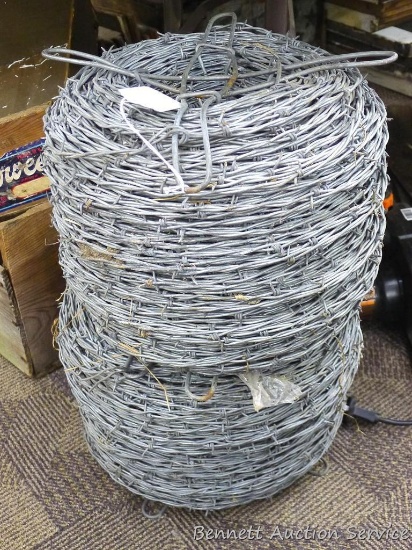 Two spools of barbed wire, look to be new. Spools are about 14" x 12".