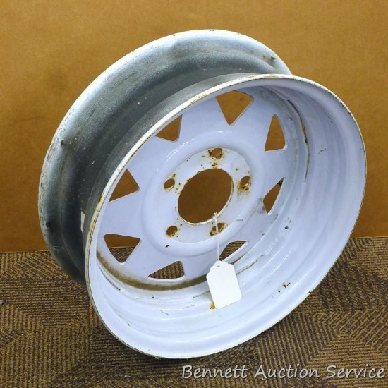 Spare trailer rim measures 16-3/8" diameter and 6" wide. Has a 3-1/4" hub hole and five holes on a