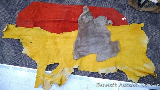 Three pieces of leather. Red leather is approx 26" x 53", main part of yellow is about 19" x 50".