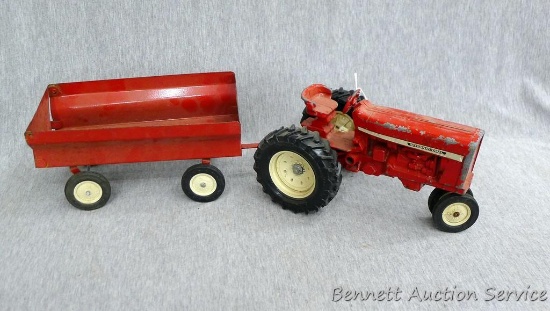 Ertl International tractor with No. 1349 wagon. Tractor with wagon is approx. 18" long.