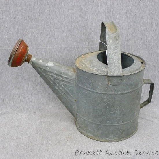 Sweet galvanized watering can is marked 10 on the bottom and stands about 9" x 15" tall. Looks to be