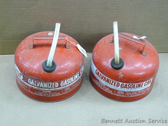 Two galvanized gas cans from before the safety spouts. Both hold 2-1/2 gallons. Spouts are stiff,