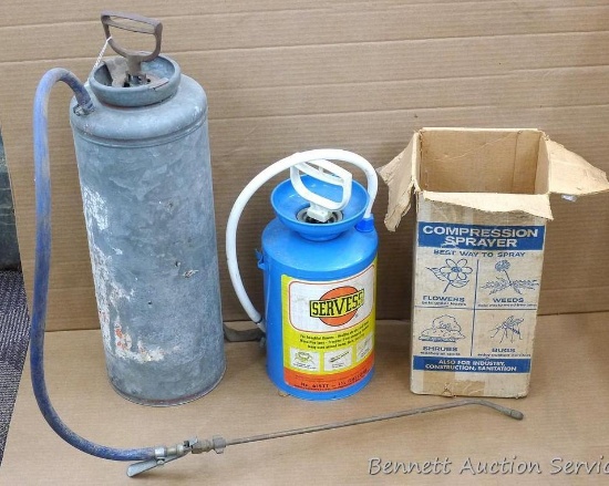 Two metal compression sprayers. Galvanized sprayer is about 8" x 24" tall, has broken strap. Other