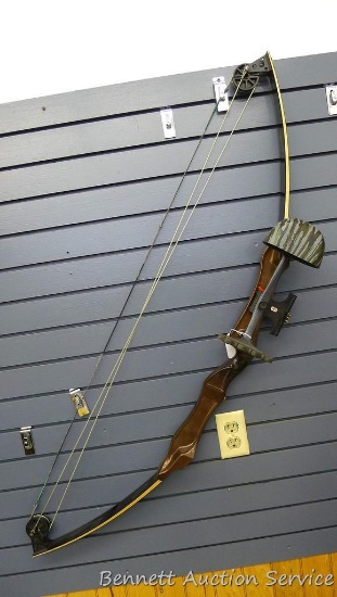 Magnesium handled compound bow with laminated limbs is 51" long. Includes sight, quiver and arrow
