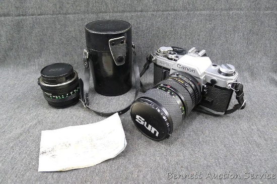 Canon AE-1 camera and a Canon 50mm 1:8 lens. Camera is about 6" x 6" x 4"; detached lens is about
