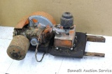 Antique 2 stroke Jacobson engine mounted on a metal bracket, has a belt pulley mounted on it, turns