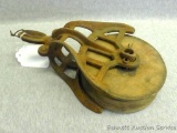 Antique wooden and cast iron pulley. Wheel is about 5-1/2