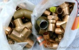 Two bags of copper fittings and connectors of various sizes.