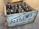 Vintage Fitger's of Duluth Minn. bottle crate holds various bottles. Sturdy crate is missing part of