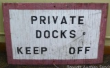 Wooden sign says ' Private Docks Keep Off' and measures 16