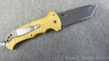 Gerber spring assisted folding knife has tanto tip, serrations, lanyard hole, pocket clip and blade