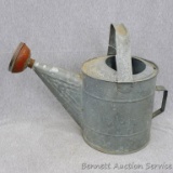 Sweet galvanized watering can is marked 10 on the bottom and stands about 9