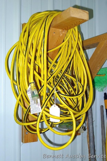 Heavy duty extension cord is approx. 100' long and has triple receptacle end. Looks like approx.