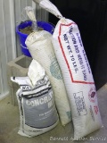Two 70 lb. tubes of traction sand, 32