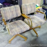 Two upholstered rolling dining chairs are in good condition and roll nicely.